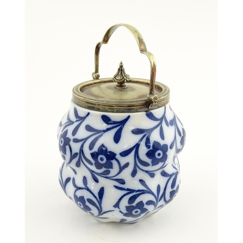 111 - A Doulton Burslem biscuit barrel of shaped form with blue and white floral and foliate decoration wi... 