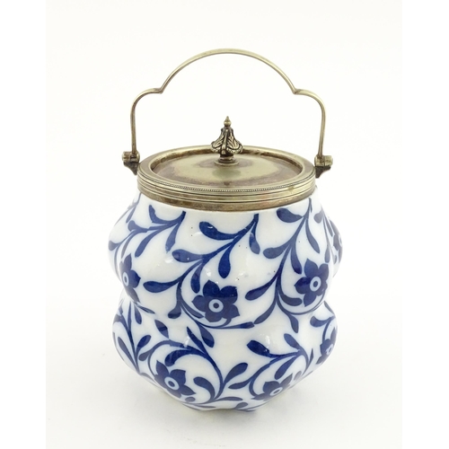 111 - A Doulton Burslem biscuit barrel of shaped form with blue and white floral and foliate decoration wi... 