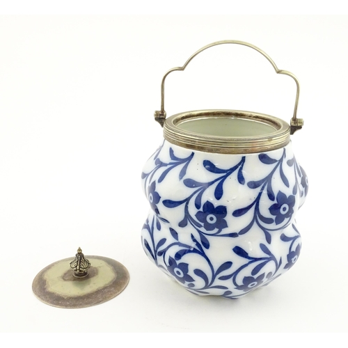 111 - A Doulton Burslem biscuit barrel of shaped form with blue and white floral and foliate decoration wi... 
