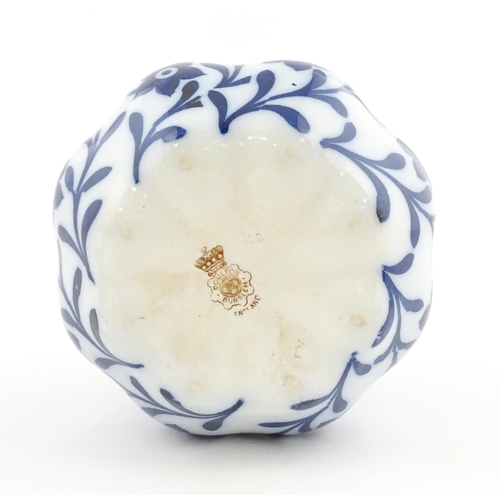 111 - A Doulton Burslem biscuit barrel of shaped form with blue and white floral and foliate decoration wi... 