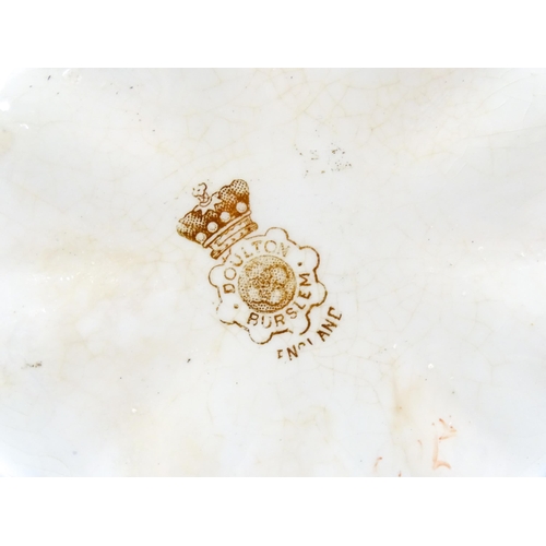 111 - A Doulton Burslem biscuit barrel of shaped form with blue and white floral and foliate decoration wi... 