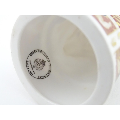 112 - A pair of Royal Worcester limited edition candle snuffers to commemorate HRH Queen Elizabeth's Golde... 