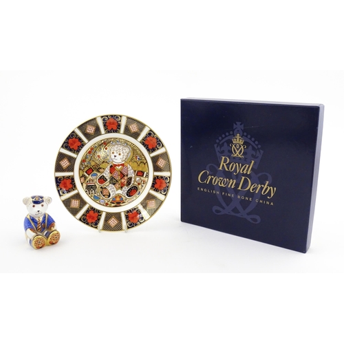 113 - A Royal Crown Derby paperweight modelled as a Schoolboy Teddy. Together with a boxed Royal Crown Der... 