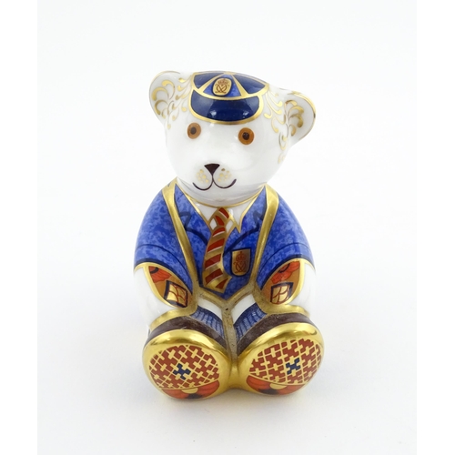 113 - A Royal Crown Derby paperweight modelled as a Schoolboy Teddy. Together with a boxed Royal Crown Der... 