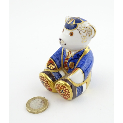113 - A Royal Crown Derby paperweight modelled as a Schoolboy Teddy. Together with a boxed Royal Crown Der... 