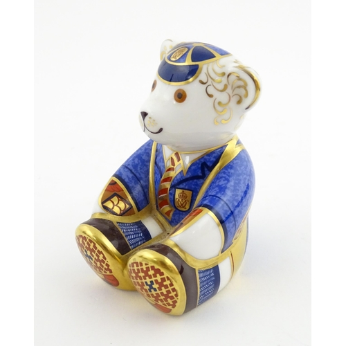 113 - A Royal Crown Derby paperweight modelled as a Schoolboy Teddy. Together with a boxed Royal Crown Der... 