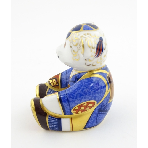 113 - A Royal Crown Derby paperweight modelled as a Schoolboy Teddy. Together with a boxed Royal Crown Der... 