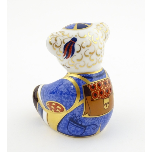113 - A Royal Crown Derby paperweight modelled as a Schoolboy Teddy. Together with a boxed Royal Crown Der... 