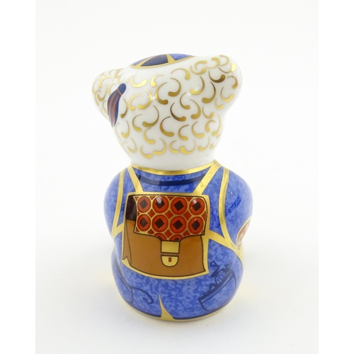 113 - A Royal Crown Derby paperweight modelled as a Schoolboy Teddy. Together with a boxed Royal Crown Der... 