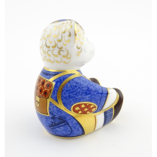 113 - A Royal Crown Derby paperweight modelled as a Schoolboy Teddy. Together with a boxed Royal Crown Der... 
