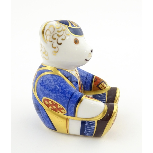 113 - A Royal Crown Derby paperweight modelled as a Schoolboy Teddy. Together with a boxed Royal Crown Der... 