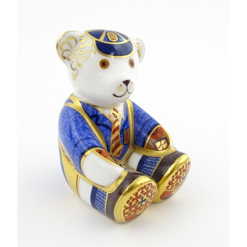 113 - A Royal Crown Derby paperweight modelled as a Schoolboy Teddy. Together with a boxed Royal Crown Der... 