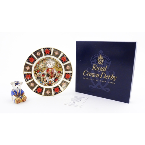 113 - A Royal Crown Derby paperweight modelled as a Schoolboy Teddy. Together with a boxed Royal Crown Der... 