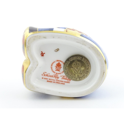 113 - A Royal Crown Derby paperweight modelled as a Schoolboy Teddy. Together with a boxed Royal Crown Der... 