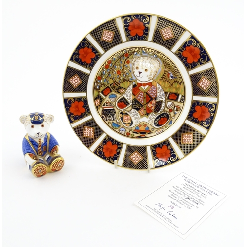 113 - A Royal Crown Derby paperweight modelled as a Schoolboy Teddy. Together with a boxed Royal Crown Der... 
