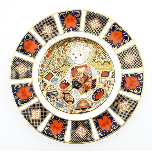 113 - A Royal Crown Derby paperweight modelled as a Schoolboy Teddy. Together with a boxed Royal Crown Der... 