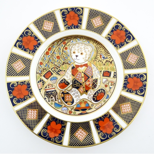 113 - A Royal Crown Derby paperweight modelled as a Schoolboy Teddy. Together with a boxed Royal Crown Der... 