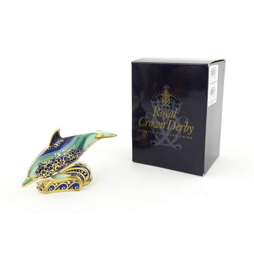 119 - A Royal Crown Derby paperweight modelled as a Lyme Bay Baby Dolphin. A signature edition of 1500 for... 