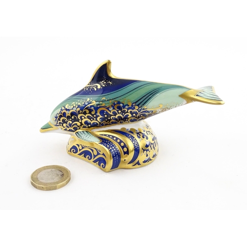 119 - A Royal Crown Derby paperweight modelled as a Lyme Bay Baby Dolphin. A signature edition of 1500 for... 