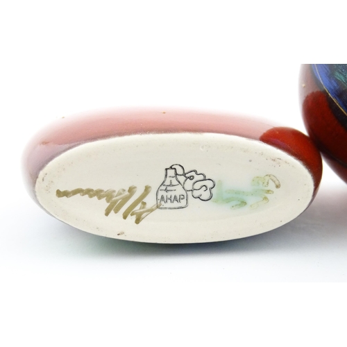 96 - A collection of Anita Harris studio pottery items to include vases and a dish with Puffin decoration... 