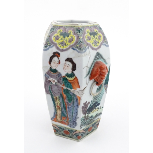 7 - A Chinese famille rose vase of hexagonal form with twin handles, decorated with male and female figu... 