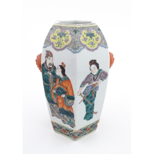 7 - A Chinese famille rose vase of hexagonal form with twin handles, decorated with male and female figu... 