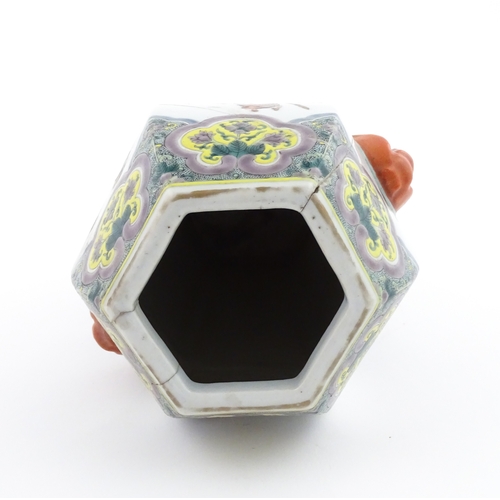 7 - A Chinese famille rose vase of hexagonal form with twin handles, decorated with male and female figu... 
