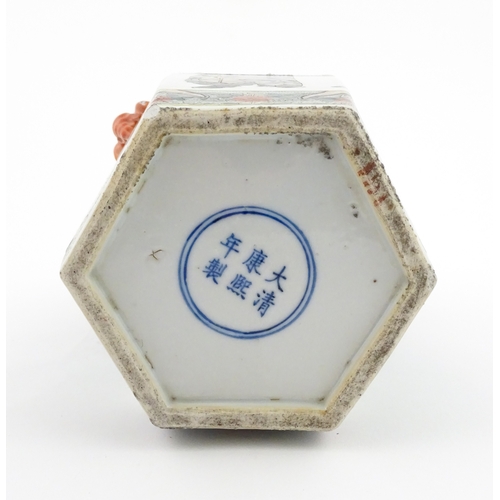 7 - A Chinese famille rose vase of hexagonal form with twin handles, decorated with male and female figu... 
