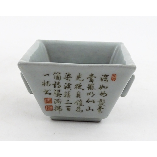 9 - A Chinese twin handled cup of squared form decorated with Character script. Character marks under. A... 