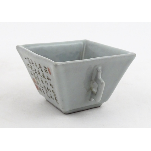 9 - A Chinese twin handled cup of squared form decorated with Character script. Character marks under. A... 