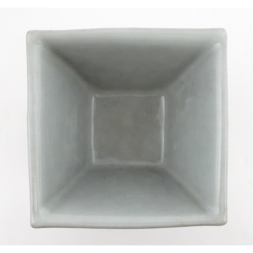 9 - A Chinese twin handled cup of squared form decorated with Character script. Character marks under. A... 