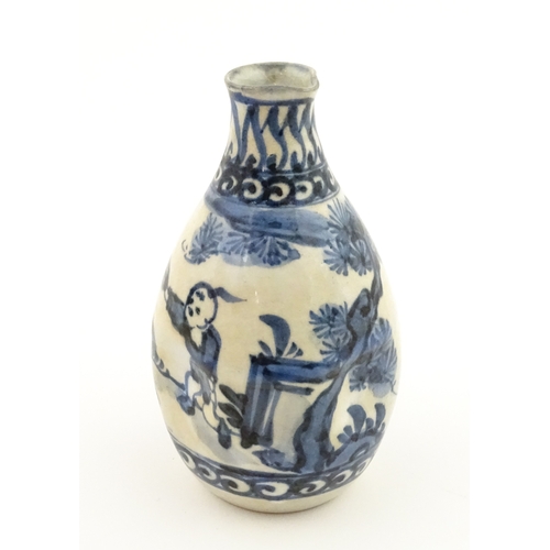 21A - A Chinese blue and white bottle vase with pinch detail decorated with a figure in a landscape. Toget... 