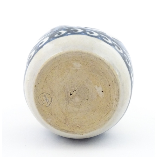 21A - A Chinese blue and white bottle vase with pinch detail decorated with a figure in a landscape. Toget... 