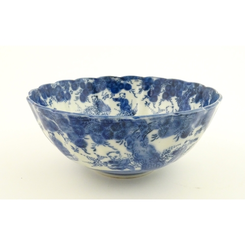 21A - A Chinese blue and white bottle vase with pinch detail decorated with a figure in a landscape. Toget... 