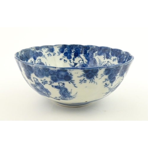 21A - A Chinese blue and white bottle vase with pinch detail decorated with a figure in a landscape. Toget... 