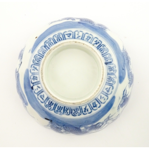 21A - A Chinese blue and white bottle vase with pinch detail decorated with a figure in a landscape. Toget... 