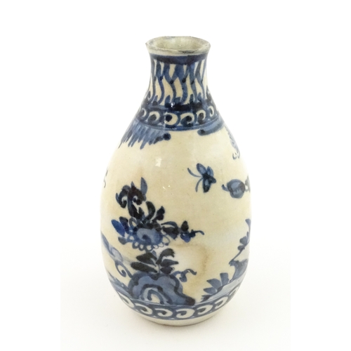 21A - A Chinese blue and white bottle vase with pinch detail decorated with a figure in a landscape. Toget... 