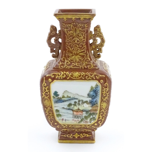 23 - A Chinese famille rose vase with brown ground and gilt highlights, decorated with landscapes and Cha... 