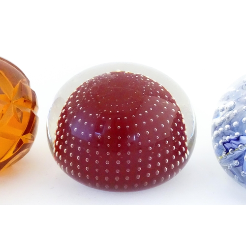 Various paperweights to include examples made by a former employee of ...