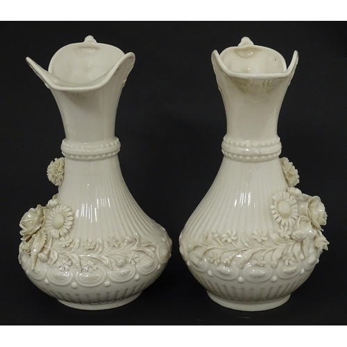 49 - A pair of Belleek Aberdeen vases / ewers with encrusted flower decoration. Both marked under with Fo... 
