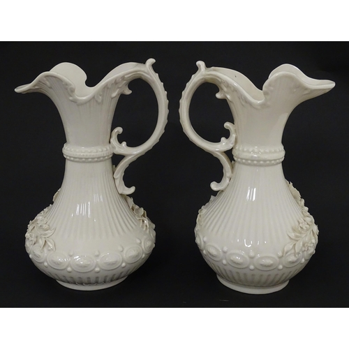 49 - A pair of Belleek Aberdeen vases / ewers with encrusted flower decoration. Both marked under with Fo... 