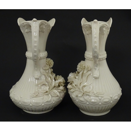 49 - A pair of Belleek Aberdeen vases / ewers with encrusted flower decoration. Both marked under with Fo... 