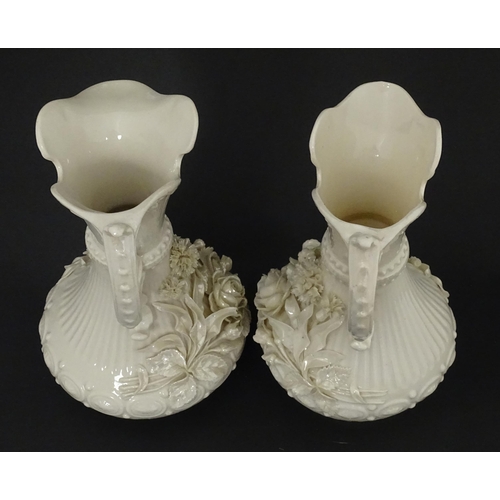 49 - A pair of Belleek Aberdeen vases / ewers with encrusted flower decoration. Both marked under with Fo... 