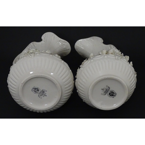 49 - A pair of Belleek Aberdeen vases / ewers with encrusted flower decoration. Both marked under with Fo... 