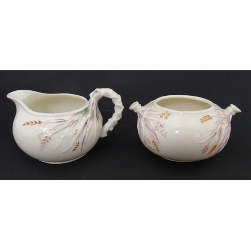 51 - Belleek tea wares in the Grass pattern to include teapots, milk jug, cream jug, teapot stand, saucer... 