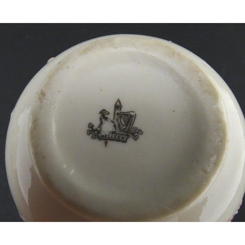 51 - Belleek tea wares in the Grass pattern to include teapots, milk jug, cream jug, teapot stand, saucer... 