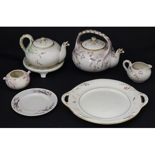 51 - Belleek tea wares in the Grass pattern to include teapots, milk jug, cream jug, teapot stand, saucer... 