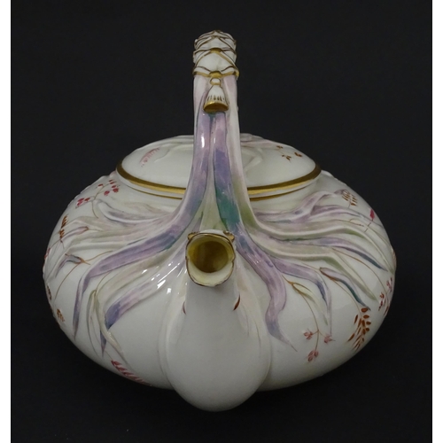 51 - Belleek tea wares in the Grass pattern to include teapots, milk jug, cream jug, teapot stand, saucer... 