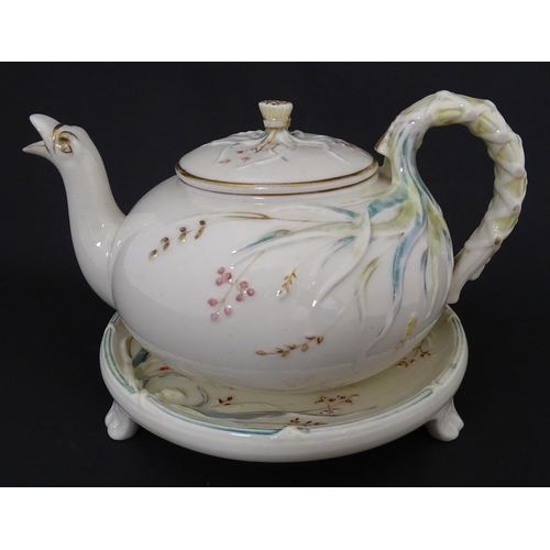 51 - Belleek tea wares in the Grass pattern to include teapots, milk jug, cream jug, teapot stand, saucer... 