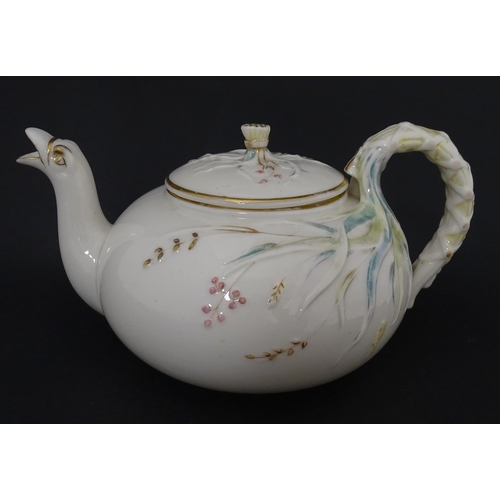 51 - Belleek tea wares in the Grass pattern to include teapots, milk jug, cream jug, teapot stand, saucer... 